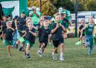 The Newcastle Pounce lead the way for their older counterparts before the NHS Bobcat HOCO game begins. The Pounce are made up of K-fifth graders who receive a shirt during pre-season, and each game receive a water and hot dog and lead the charge coming ou
