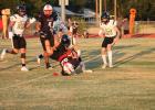Cubs #22 Kyle Stewart is tackled by a Wildcat defender in Olney’s Sept. 18 Homecoming game against Archer City at Cub Stadium. The Cubs prevailed in the high-scoring contest, 42-36. Photo by Kailyn Altmiller