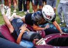 A Bobcat mom tackles her son during the Tackle with Moms event. Photo by Will Sadler