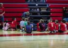 At the end of each basketball skills session, attendees answered trivia questions for chances at prizes and received tokens for achievements made during the day’s camp session. The attendees keep track of the tokens by attaching them to shoelaces on mak
