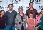 Piper Meshkat, Justin Piegat, Carla Perry, Aurelia Meschkat, DJ Meschkat, Fenya Meschkat and Claire Meschkat celebrate Mrs. Perry’s Pioneer Award at the 100th Olney Chamber banquet. Photo by Will Sadler