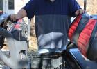 Steven Kinyk works his mechanic’s magic on a golf cart. Mr. Kinyk is Olney’s mobile auto mechanic. Photo by Gina Keating