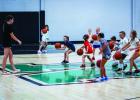 The children attending the summer basketball camp had fun competing against each other in dribbling drills. Photo by Will Sadler
