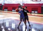 Two Cubs practice offense and defense under the basket. During camp, there are many ways to earn prizes, but the best is bragging rights over friends and fellow camp attendees. Photo by Will Sadler