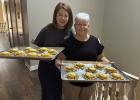 Melissa Edgington and Barbara Cowert make snacks for FBCO’s Vacation Bible School. Photo by FBCO