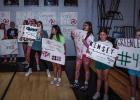 Young Ladycats made signs supporting their older counterparts during the Ladycats Varsity Volleyball Senior Night. Photo by Will Sadler