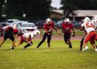 OHS quarterback #11 Tucker Cortinez breaks out of the pocket to pick up yardage. Photo by Will Sadler