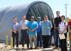 City officials stand in front of the DOW demonstration unit at the Olney Water Treatment Plant, along with representatives from Jacob | Martin, and competitor Aria Filtra, whose unit was also placed at the site. A third vendor, Purifics, withdrew from the