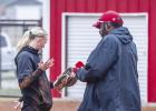 The Lady Cubs had a cold drizzly start to their district matchup with rival Lady Panthers. OHS Lady Cubs pitcher #1 Kynlee Lauderdale dries off the game ball with the help of the Lady Cubs Coach Justin Tate. Photo by Will Sadler