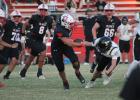 Cubs #54 A.J. Solano tangles with a Wildcat defender in Olney’s Sept. 18 Homecoming game against Archer City at Cub Stadium. The Cubs prevailed in the high-scoring contest, 42-36. Photo by Kailyn Altmiller