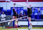 Two Ladycats go up at the net for a block. Photo by Will Sadler