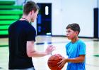 Coach Lane Dollar gives one-on-one instructions to a camp attendee. Photo by Will Sadler