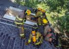 OVFD firefighter Len Bernhardt led the training on how to breach a roof and explained the importance of communication and safety with the teams in the house. Photo by Will Sadler