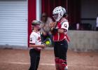 Lady Cubs pitcher and catcher have an impromptu meeting during the first game. Photo by Will Sadler