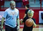 Coach Symank is teaching a large group of children basketball skills over the summer, which includes one on one coaching time. Kids also learn teamwork, passing, dribbling, shooting and good sportsmanship along with many other useful skills. Photo by Will
