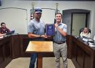 Olney Mayor Rue Rogers presents Public Utilities director Michael Jacoba with an award from the Texas Water Utilities Association at the June 23 Council meeting. Photo by Dale Lovett