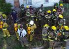 Firefighters review breaching and safety after the first teams had a run-through. Photo by Will Sadler