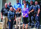 Olney Police Department Employees and Officers pose one last time with outgoing Olney Police Chief Dan Birbeck. Photo by Will Sadler