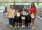 Lori Cox, director of the Olney Community Library and Art Center stands with the winners of the America’s 250th birthday coloring contest winners Grant Blevins (3rd place), May Stewart (2nd place), and Henry Blevins (1st place) and coloring contest judg