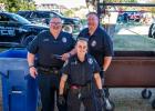 Olney Police Department kept attendees fed with some delicious hot dogs. [L] Officer Shane Vandiver, [R] Chief Bryan Barrett, and [F] Officer Montana Calcote. Photo by Will Sadler