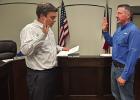 Olney City Attorney Dan Branum swears in Olney’s new city administrator, Andy Wolfe at the June 8 City Council meeting. Mr. Wolfe starts at his new post about nine months after the departure of former city administrator Simon Dwyer. Photo by Dale Lovett