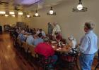 The OEDC board held a lunchtime meeting at Old Time Cafe to discuss an ambitous plan for 2026-27 fiscal year with state and federal officials, as well as structural engineers and city officials. Tom Parker (R) explains the plan to attendees. Photo by Gina