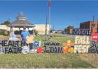Spencer Key and his signs have become a staple on Main Street and in yards across Olney, letting the community know about milestones and goings-on. Photo by Will Sadler