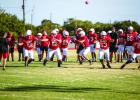 The Cubs Offensive line is confident this season, with a seasoned running back in Kyle Stewart. Cubs warming up before their scrimmage with the Eagles. Photo by Will Sadler