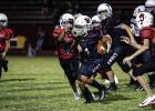 Cub Midget #32 Denis Geter races in to tackle the Lion runner. Photo by Will Sadler