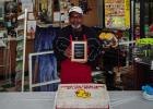 Don Atkinson receives a plaque from Stewart’s Food Store for 20 years of service at the family-owned grocery store at a special celebration last week. Photo by Will Sadler