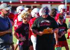 Son Ryan Keeter looks on at his dad, Coach Casey Keeter, with a proud look. Photo by Will Sadler