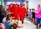 Olney High School Seniors take a traditional stroll down Olney Elementary School’s Hall in cap &amp; gown before graduating. The children really enjoy the high fives and hugs. Photo by Will Sadler