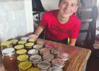 Young beekeeper checks in a year after starting his hive