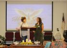 Debbie Shelley welcomes Angela Lockard, executive director of the Olney Senior Cub Center, to the podium at the Holy Spirit Reign Down Ladies Conference at Southside Baptist Church in Olney on Sept. 18-19. Ms. Lockard was one of several women who gave tes