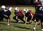 Cub Midgets #55 Creed Sandlin [L] and #50 Blaine Owen [R] hold the line for the Cubs, protecting the Quarterback and opening holes in the defensive line for Cub Runners. Photo by Will Sadler