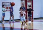 Cubs practiced passing during basketball summer camp by racing down the court passing the ball between players. Photo by Will Sadler