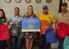 Atmos Energy employees deliver backpacks to Olney Elementary School: (L-R): Pam Hughes Pak and Carlos Trevino, Assistant Principal Kalynn Philipp, Atmos Energy’s Riley Whitson and Trevor Whitsitt. Photo provided by Atmos Energy