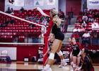 Lady Cub #3-Bradi Bowers sends a kill shot over the net towards Lady Trojan defenders. Photo by Will Sadler