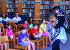 Ms. Maria uses puppets to entertain and teach children during her Cool School story time at the Olney Library. Photo by Will Sadler