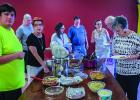 Attendees of the Cub Center June Game Night line up to fill their plates with delicious treats while chatting with each other about happenings around town. Photo by Will Sadler