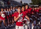 OHS Cub Kyle Stewart, running back and linebacker for the Cubs, shows emotion and pride at the head of the Cubs during the National Anthem. Photo by Will Sadler