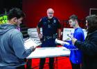 Olney Police Department’s Chief Dan Birbeck hosted a table where seniors could spin a wheel and receive a non-planned bill or hardship, prompting discussions of how to adjust a monthly financial plan. Photo by Will Sadler