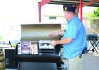 American Legion Post 414 Chaplain Steven Nurre shuffles the raffle tickets at the May 2 drawing at ACE Hardware in Olney. The proceeds of the raffle will help Legion Post 414 carry out its programs. Photo by Gina Keating