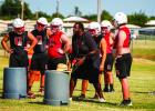 OISD Coach Justin Tate works with the offensive line during afternoon practice. Photo by Will Sadler
