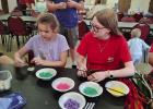 Katherine Garcia and Grace Jeske make Trees of Life during the crafts portion of the St. Luke Lutheran Church’s family night on June 18. Photo by Gina Keating