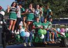 Newcastle High School adorned floats and trailers to proudly parade down Newcastle’s streets during Homecoming Week. Shown are the NHS cheerleaders and Bobcat footballers. Photo by Will Sadler