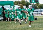 NHS Bobcat #18 Keyton Newland, RB/QB, leads fellow teammates out of the Bobcat tunnel onto the field before the Guthrie match.