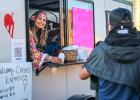 Mari Behrens, proprietor of Calvary Cones Express, passes out frosty treats to Halloween revelers at the Olney Chamber’s Trunk or Treat event, Photo by Gina Keating