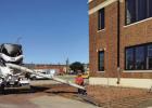 Construction crews repaired the sidewalk on the south side of the Olney Sub Courthouse to make way for a new access ramp and a child custody drop-off area with cameras. The old courthouse underwent a major restoration, including new HVAC, windows, paint,