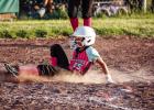 A Young Gun slides into home plate scoring a point to help add to the win for the day; she was all smiles. Photo by Will Sadler